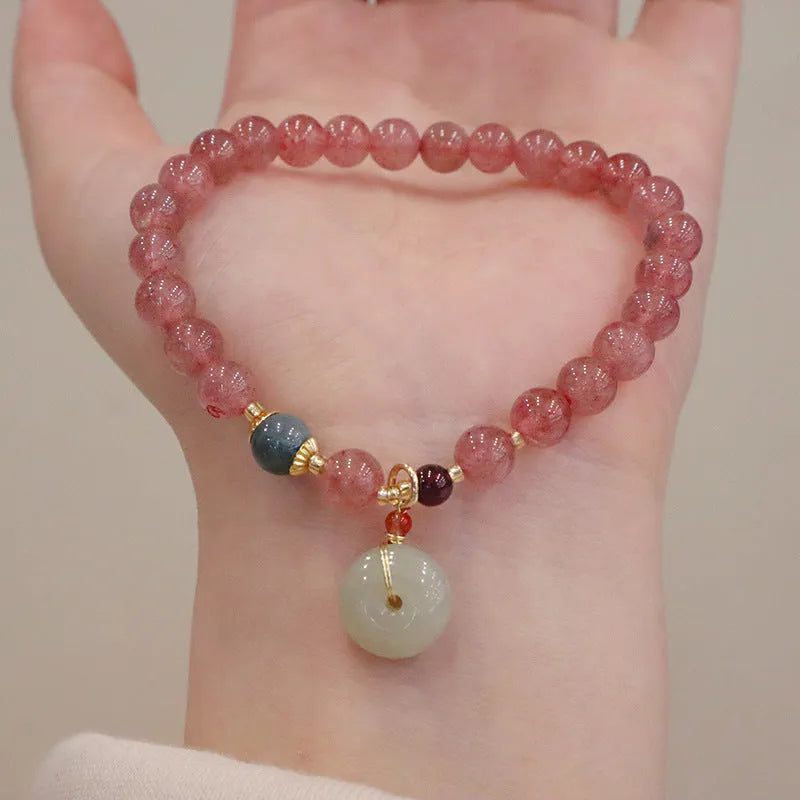 Geometric strawberry quartz women's bracelet with a lucky bag charm and silver safety buckle on a white background.