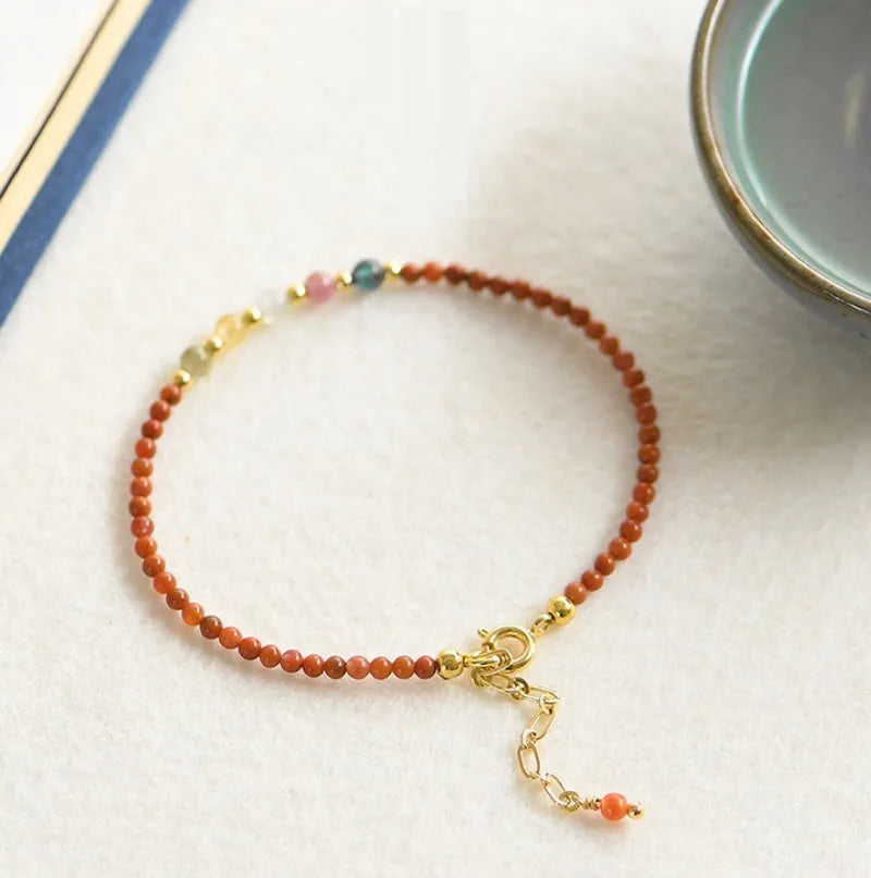 Simple geometric women's bracelet with natural freshwater pearls and crystal details on an elastic rope band.