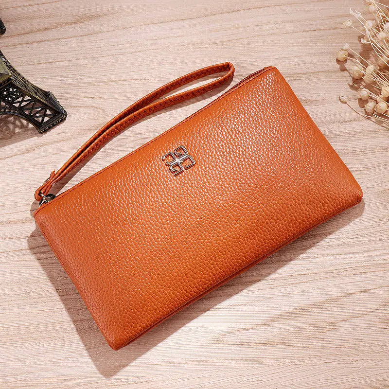 Long slim wine red PU leather wallet handbag with a top zip, shown open to reveal card slots and a phone pocket.