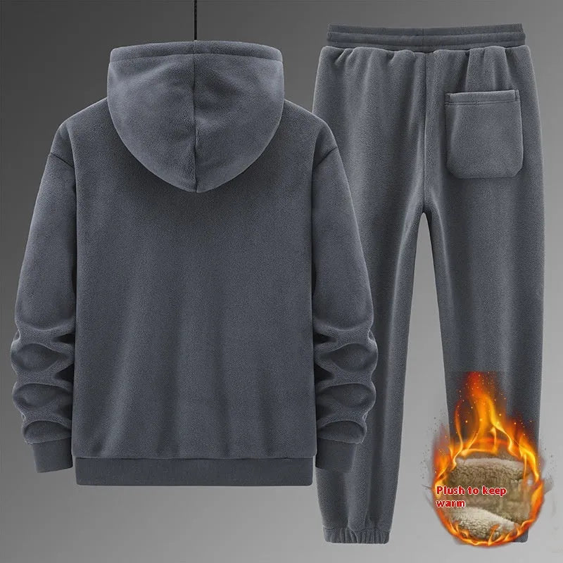 Man wearing a grey hooded sweatshirt and matching tracksuit pants from a casual two-piece set.