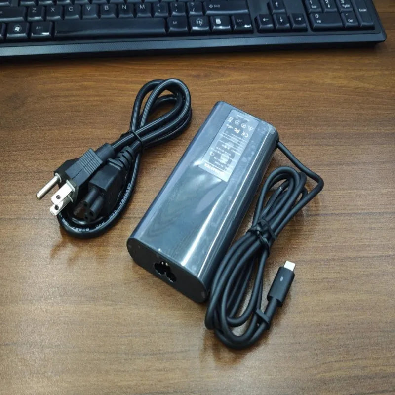 Black 65W laptop Type-C power adapter with multiple international plug cords