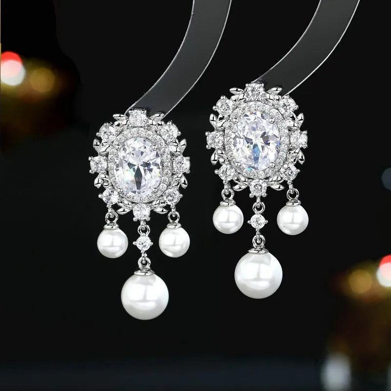 Oval geometric earrings with zircon inlay and tassel detailing in light purple colour