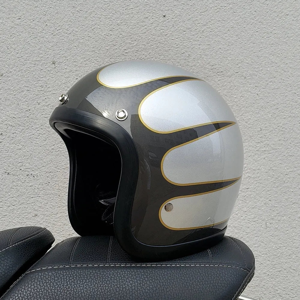 Retro-style open-face motorcycle helmet in fibreglass, shown in a choice of colours including Cement Grey and Matte Black Flower.
