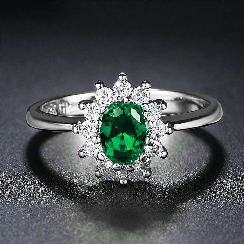 Copper floral women's ring with inlaid zirconia stone in green, blue, or red colour on a white background.