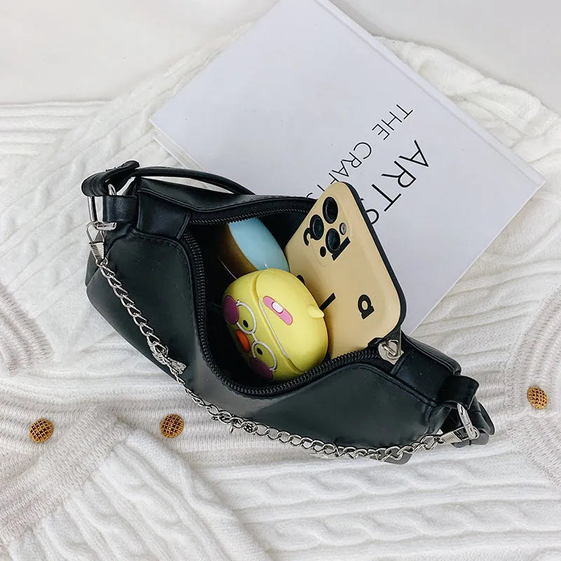 Women's black PU leather butterfly chain underarm bag showing crossbody wear with retro styling