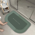 Machine-woven blended bathroom floor mat in blue, shown in an oval shape on a tiled floor.