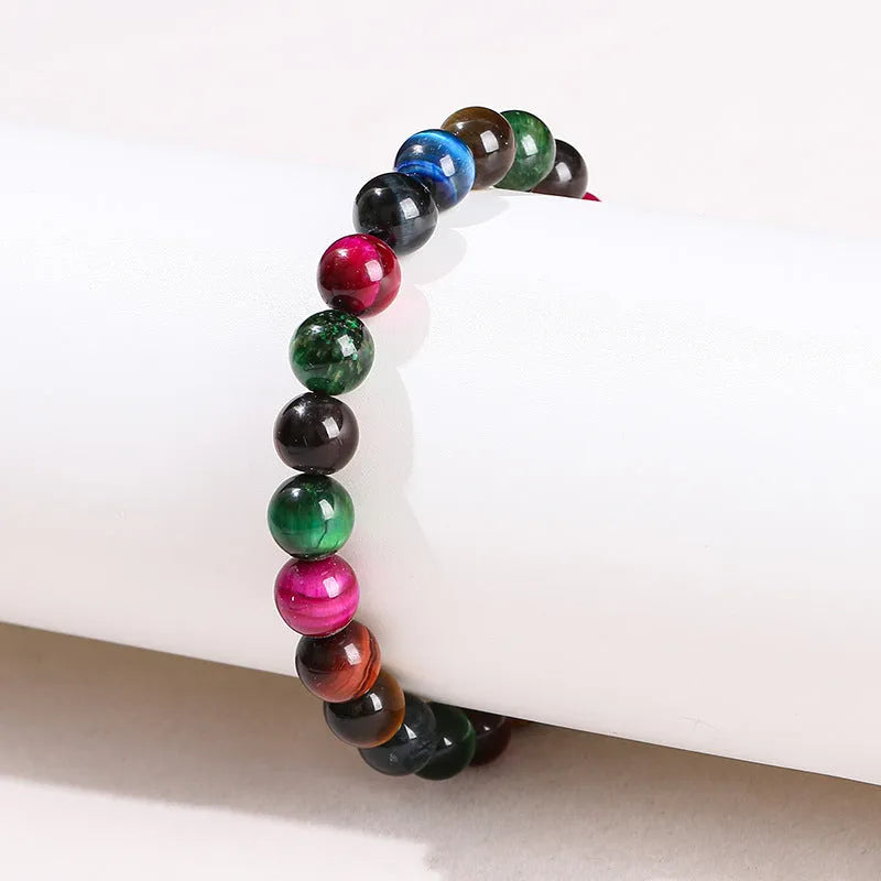 Colourful tiger's eye natural stone bracelet with round beads on a string lace, shown in unisex design.
