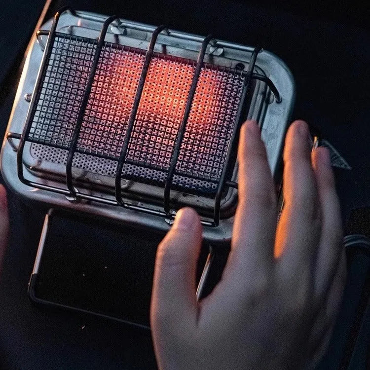 Outdoor heating stove with voltage regulator showing metal construction and compact folded design
