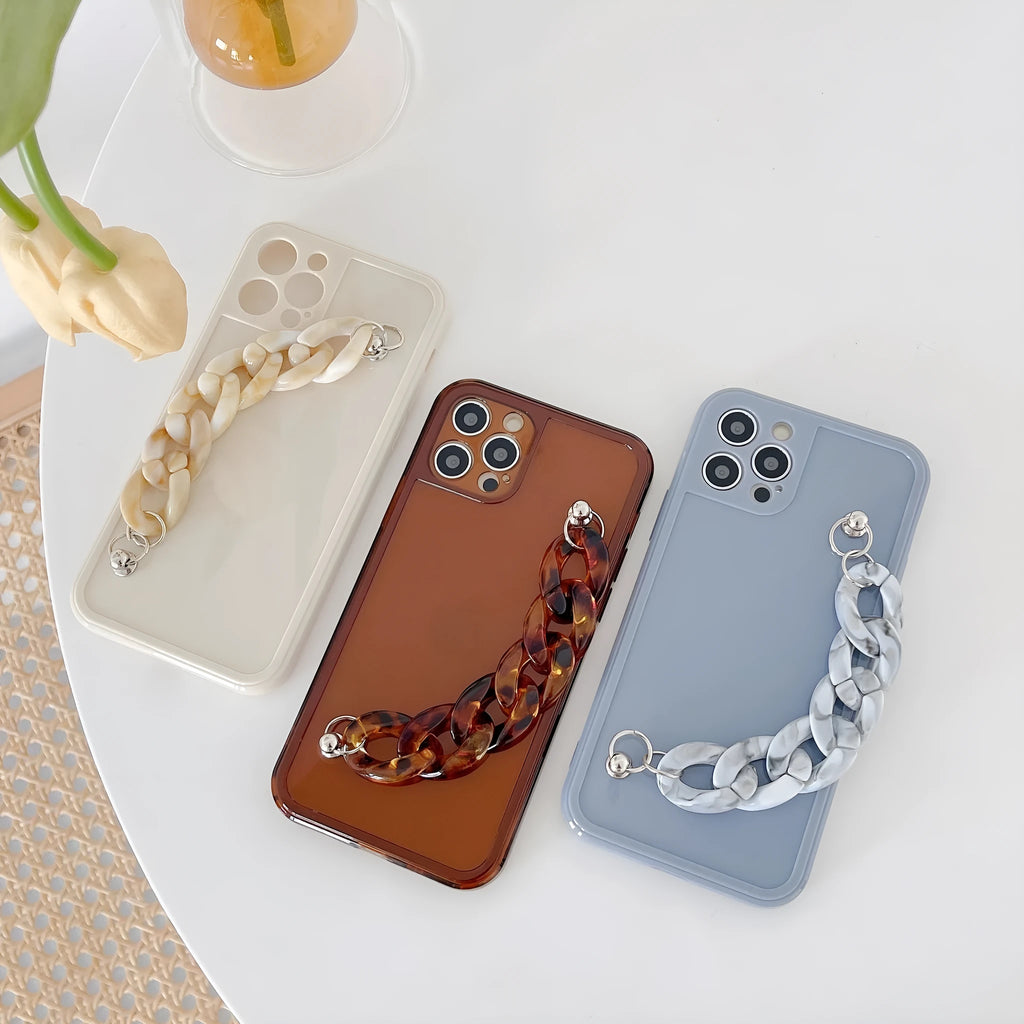 Marbled silicone phone case for iPhone with side lanyard hole in antique white, grey blue, and transparent coffee colours.