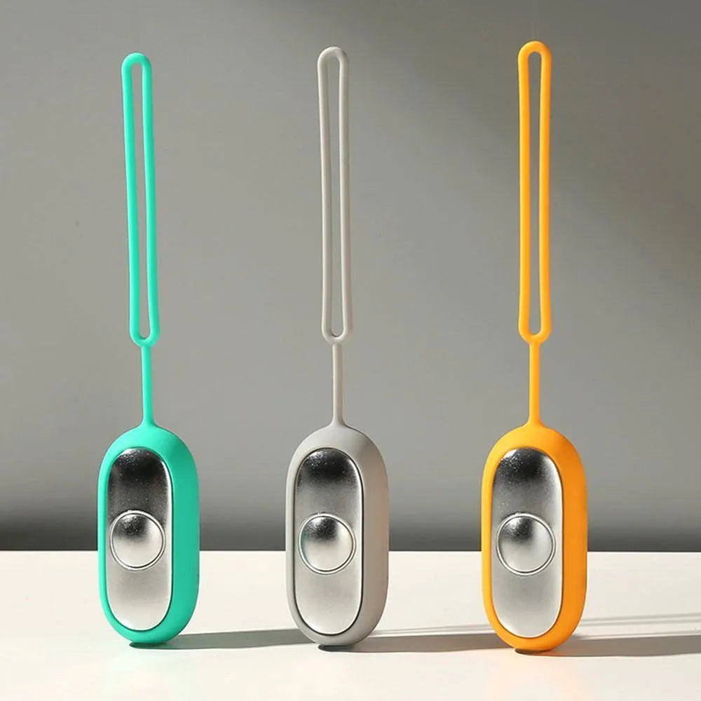Handheld micro-current sleep aid device in grey, green, or orange colours with USB charging cable