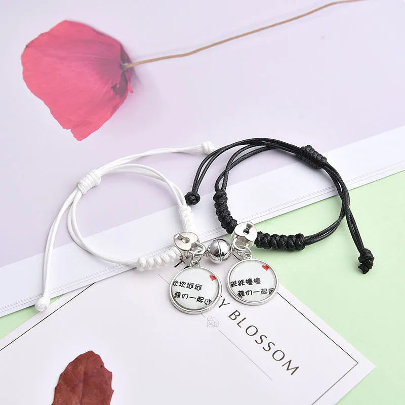 Magnet suction couple bracelets with alloy construction and various pendant designs including crowns and hearts