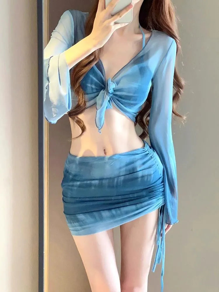 Women's blue high-waisted bikini four-piece swimsuit set with shirt, bra, underwear, and skirt for beach wear