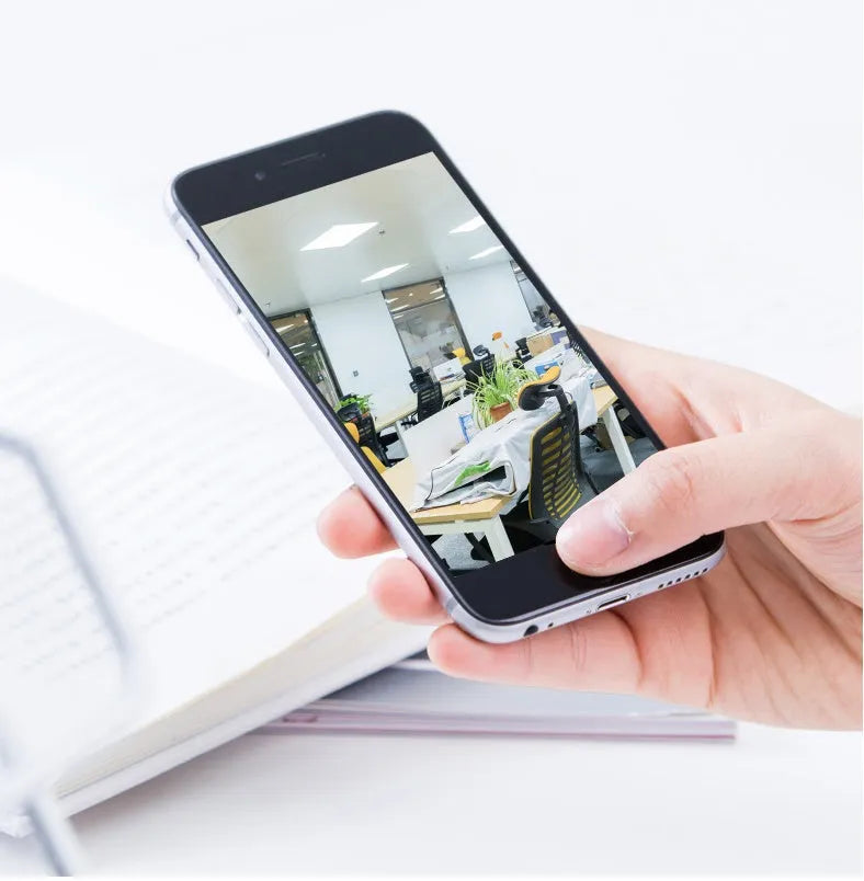 White indoor WiFi security camera with 360-degree rotation on stand showing 2MP resolution and optional memory card storage