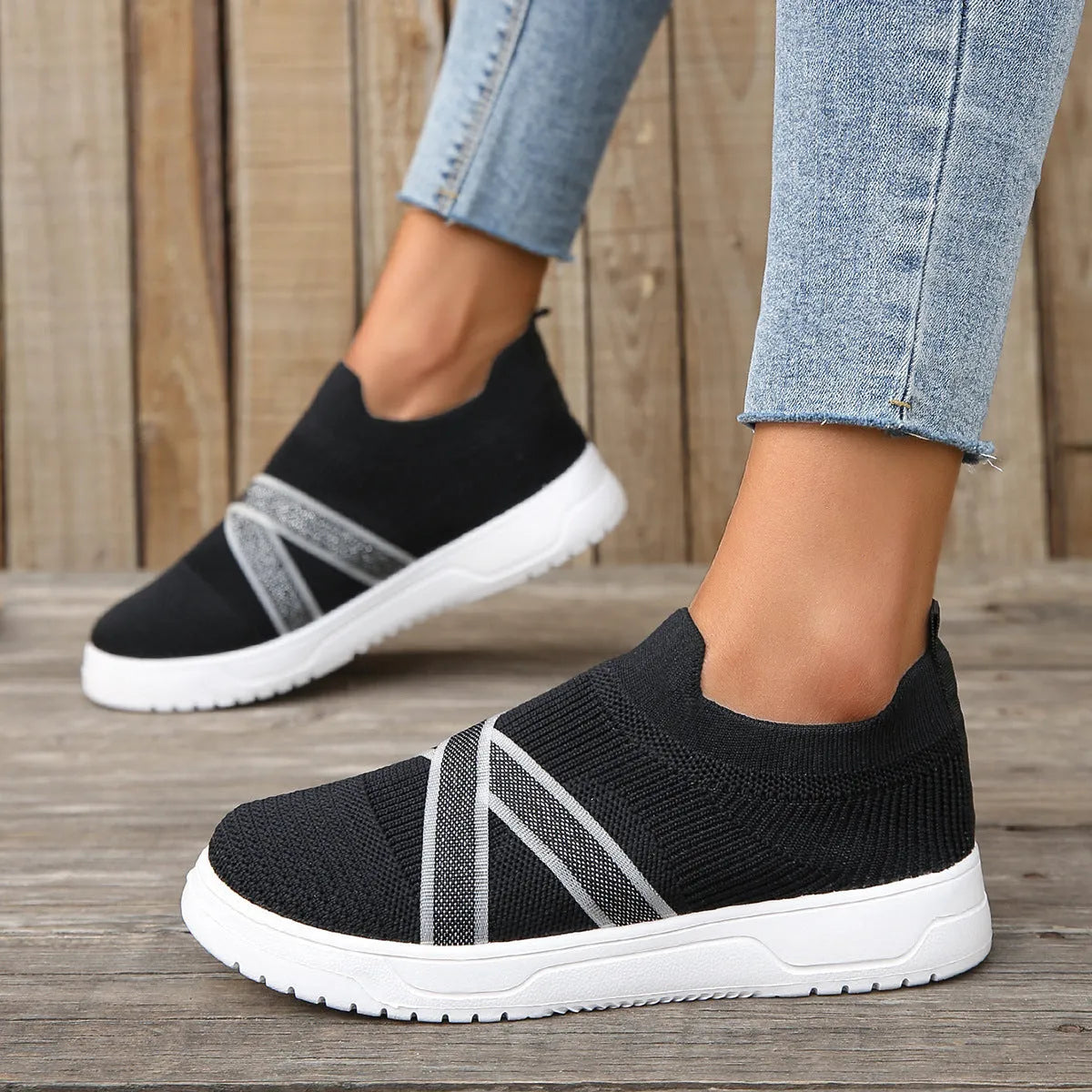 Black women's flyknit mesh shoes with flat rubber sole and tassel detail