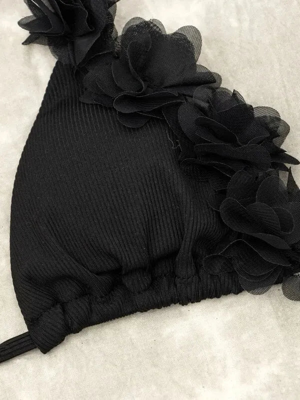 Black women's two-piece swimsuit set with gathered design, featuring a top and shorts.
