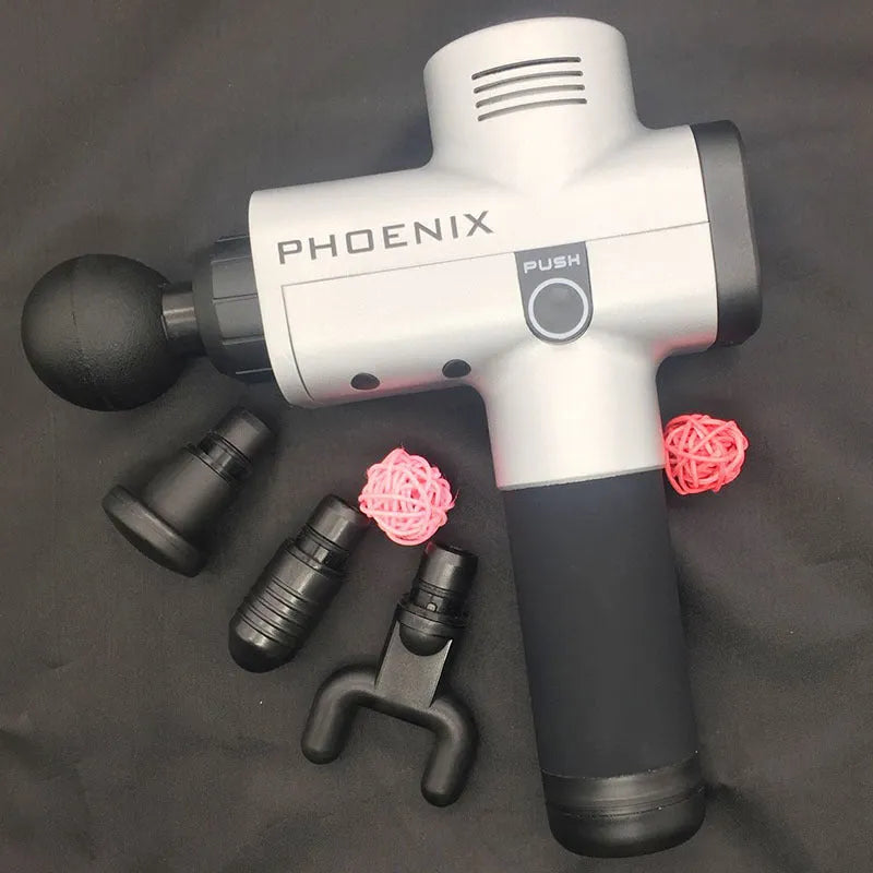 A black or silver ABS plastic percussion massage gun with four different removable massage heads on a table.