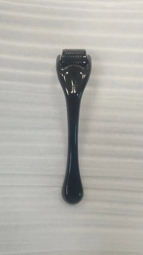 540 micro needle roller tool with black handle and coloured wheel on a white background.
