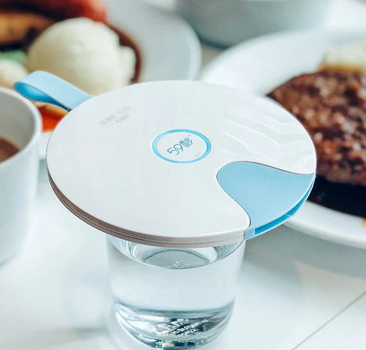 Slim blue portable UV baby bottle steriliser with USB port shown next to a baby bottle.