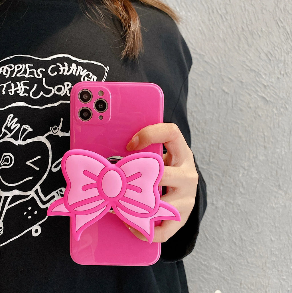 Rose red iPhone case with a large pink bow and a folded-out kickstand on the back.