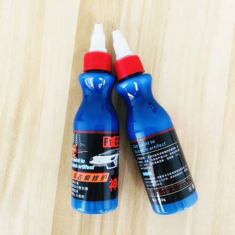 Small blue bottle of car scratch repair agent for wipe-on application to vehicle paint surfaces