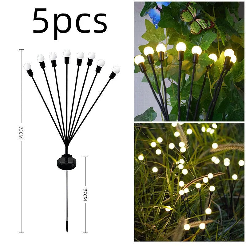 Solar-powered LED firefly garden spike light with multiple heads and a press-in ground plug on grass.