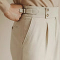Men's slim fit straight leg suit trousers in black, white, or apricot colour on a hanger.