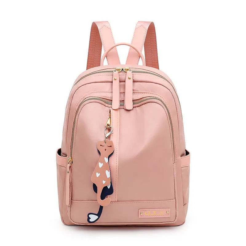 Black and pink casual nylon backpack with double straps, soft handle, and external pocket.