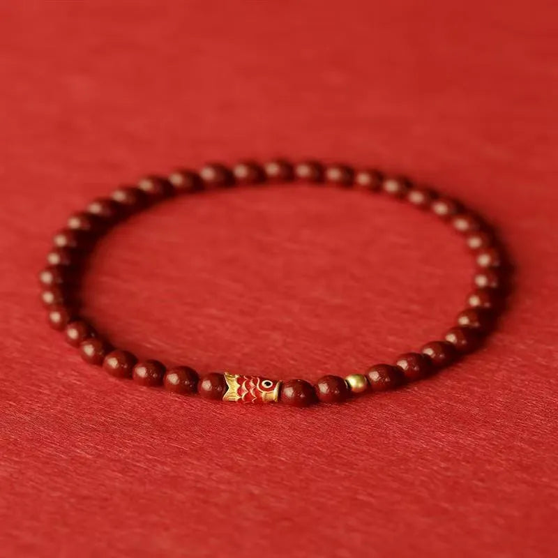 Handmade natural cinnabar koi bracelet with golden ball in national style