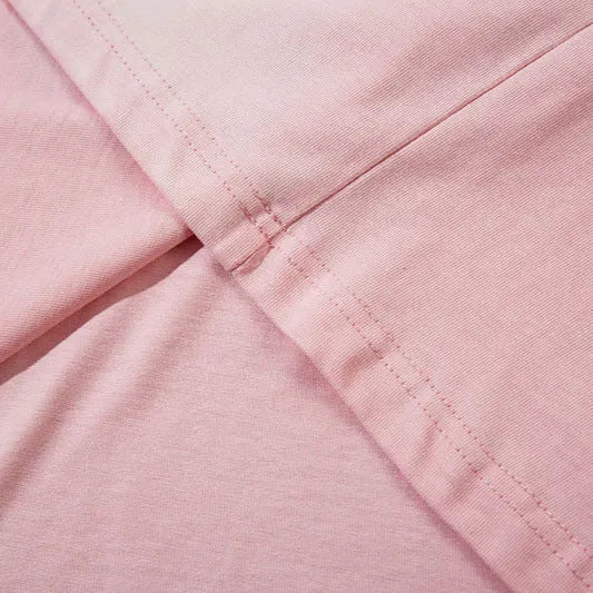 Women's loose casual pullover top in 100% cotton with drop-shoulder sleeves available in dark grey and pink colours