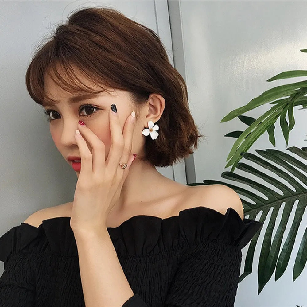 Alloy flower stud earrings with electroplated finish in white and pink colour options