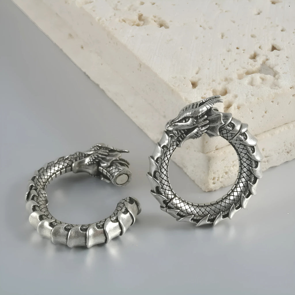 Retro geometric dragon silhouette earrings in antique silver, showing hollow-out design and large size.