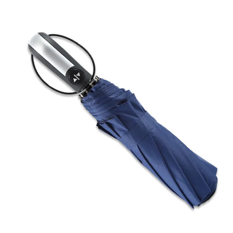 Open black automatic triple-folding business umbrella with a large canopy and rubber handle.