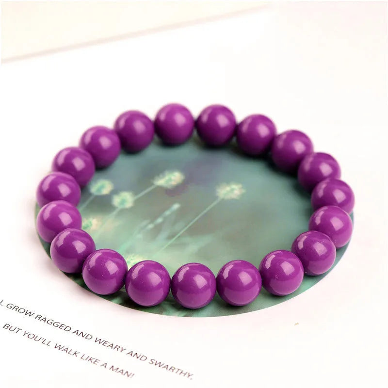 Jiuya purple mica crystal bracelet showing polished beads in a single circle design on a wrist.