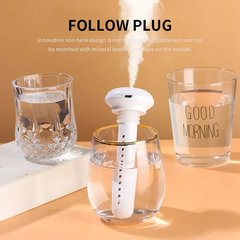 Donut mini humidifier USB car sprayer 54mm x 220mm in ABS and silicone, shown in Beige Elk, Pink Elk, or White