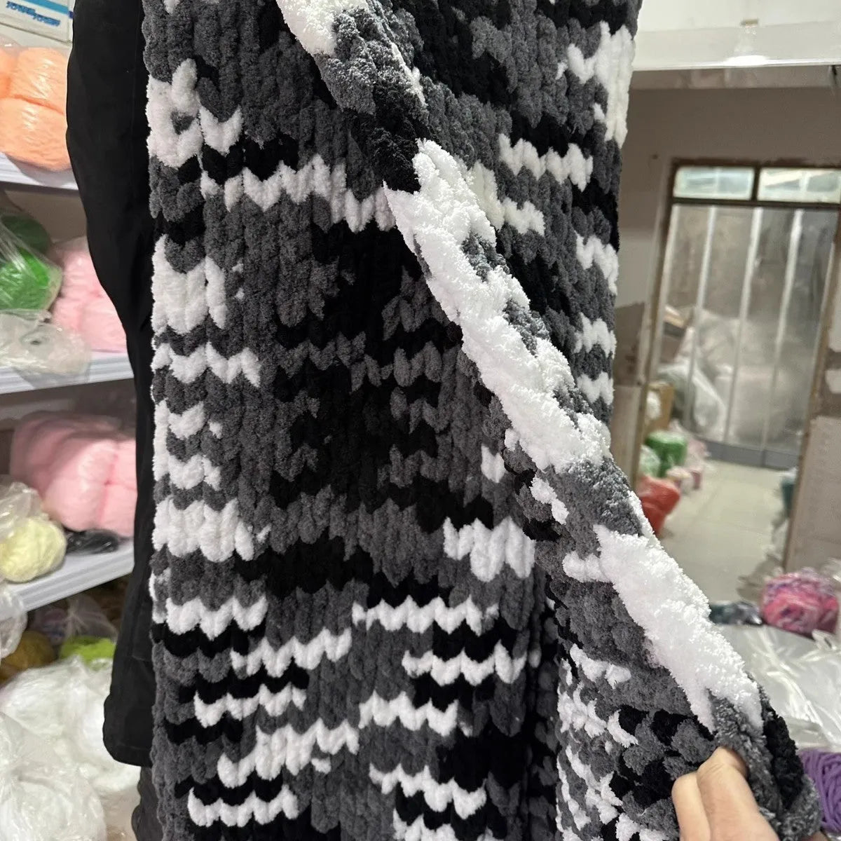 Coarse yarn chenille knitted blanket with braided gravity detail in modern colour option