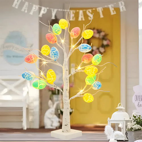 White plastic birch tree Easter decoration with warm white LED lights and hanging coloured eggs on adjustable branches.