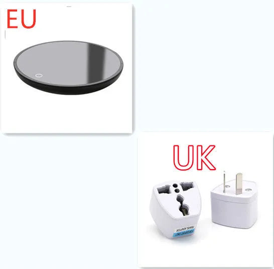 Black round desk cup warmer with tempered glass surface and low high switch on a wooden table.