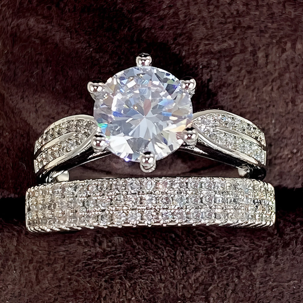 White gold colour geometric wedding ring bracelet on a finger, showing combined ring and band design.