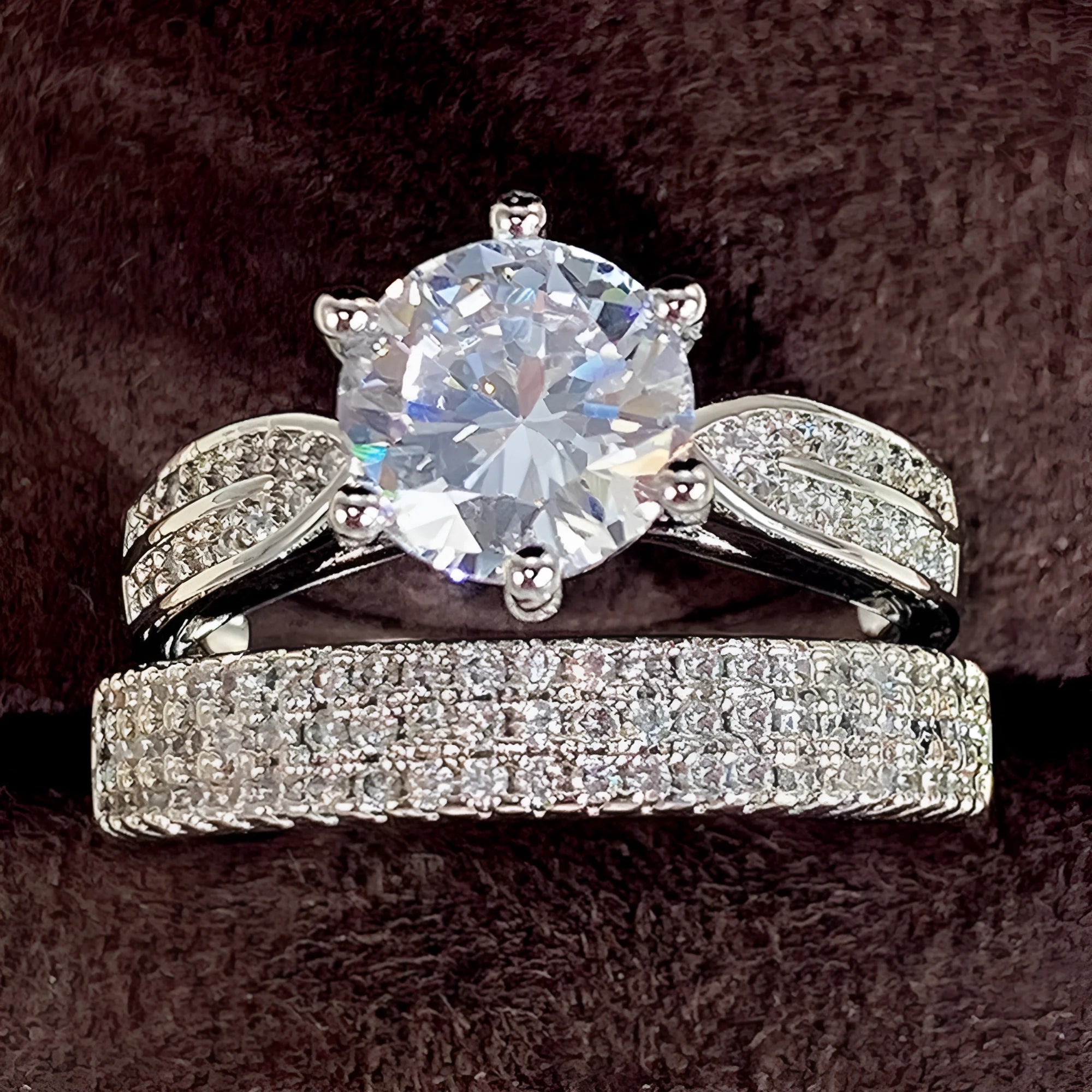 White gold colour geometric wedding ring bracelet on a finger, showing combined ring and band design.