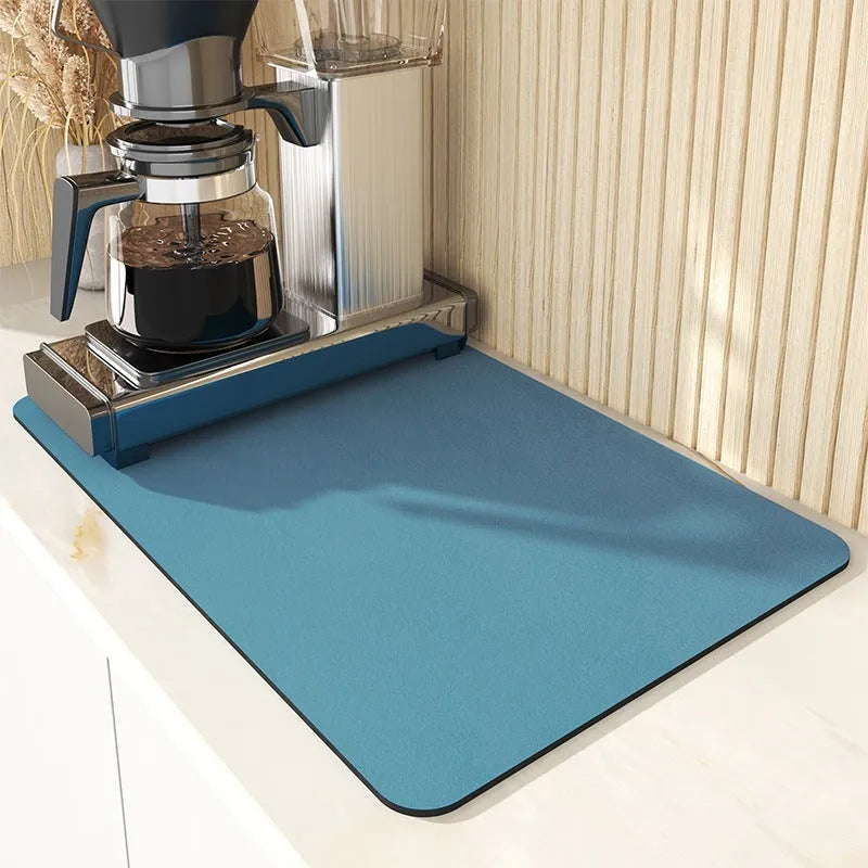 Black square kitchen drain drying mat with anti-slip rubber backing on a countertop