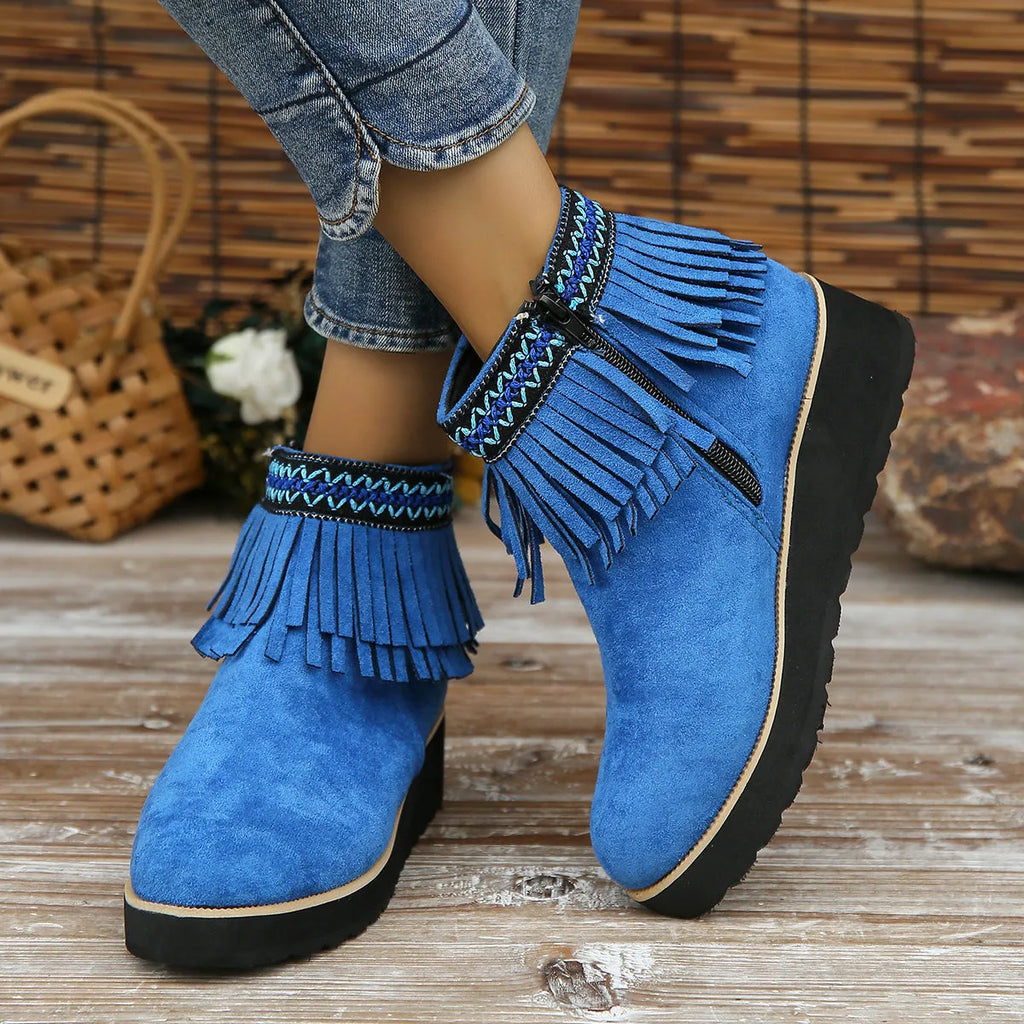 Women's suede wedge ankle boot with tassel detail, side zip, and a thick rubber sole.