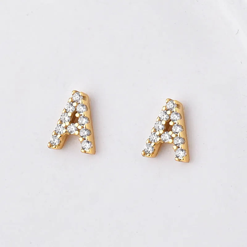 Gold plated copper stud earrings showing a single English letter, part of a full alphabet set.