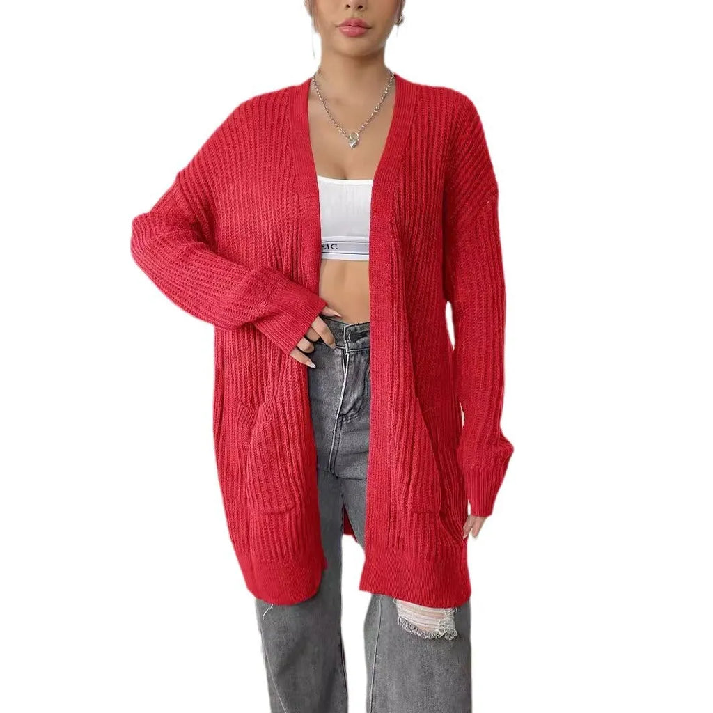 Dark green loose women's cardigan with two pockets and long sleeves.