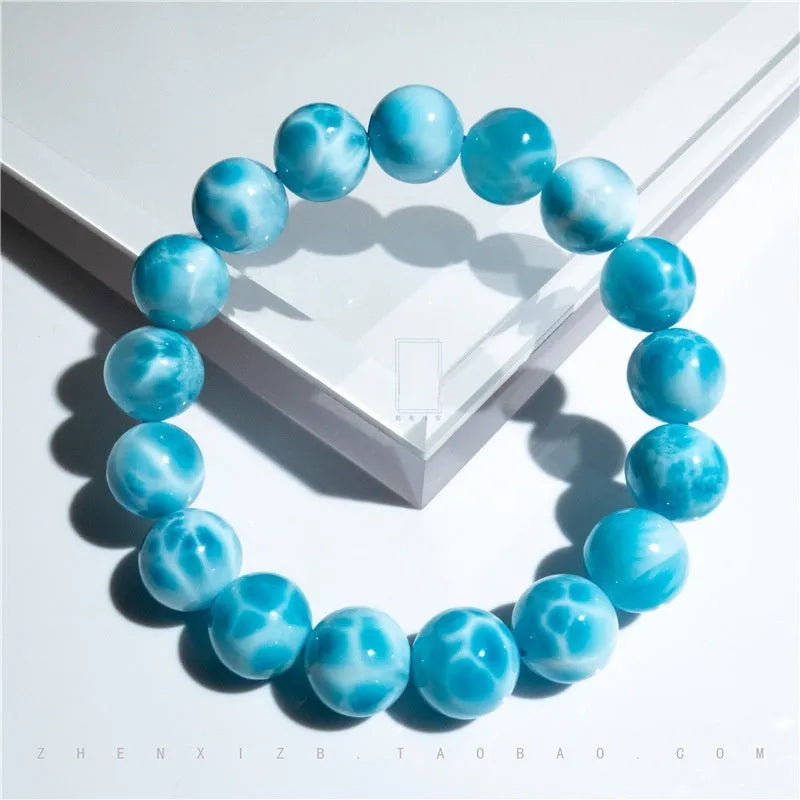 Blue handmade Bodhi bracelet with natural crystal, sea-pattern stone, and pearl in Maillard style.