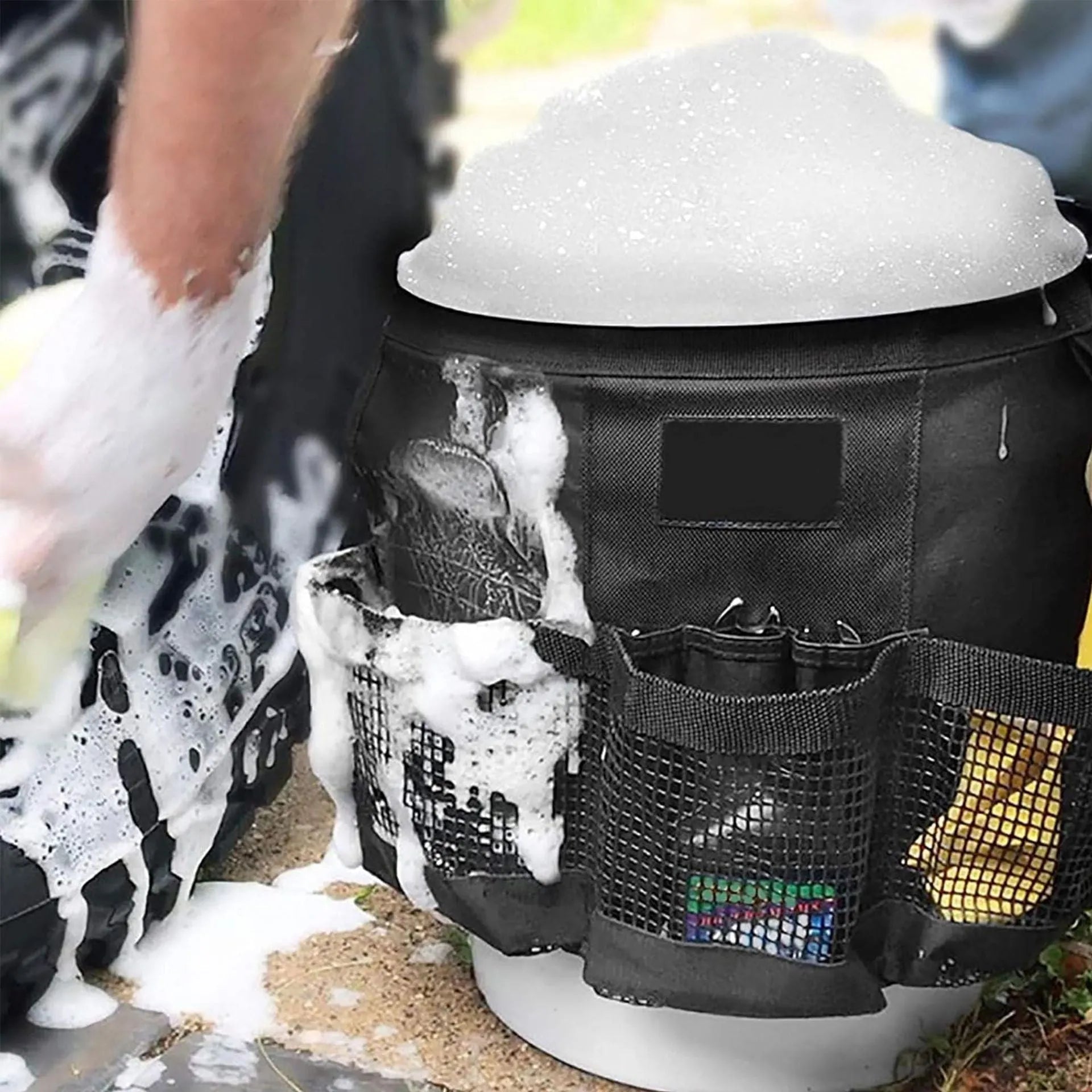 Black cylindrical polyester buggy storage bag hanging from a 5-gallon barrel.