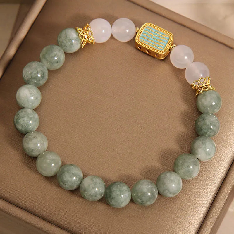 Women's oil green emerald crystal bracelet with five-piece sutra design on wrist.