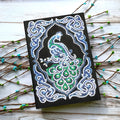 Black A5 Peacock Beauty diamond painting notebook with sparkling shaped drills on cover, showing 142x207mm size.