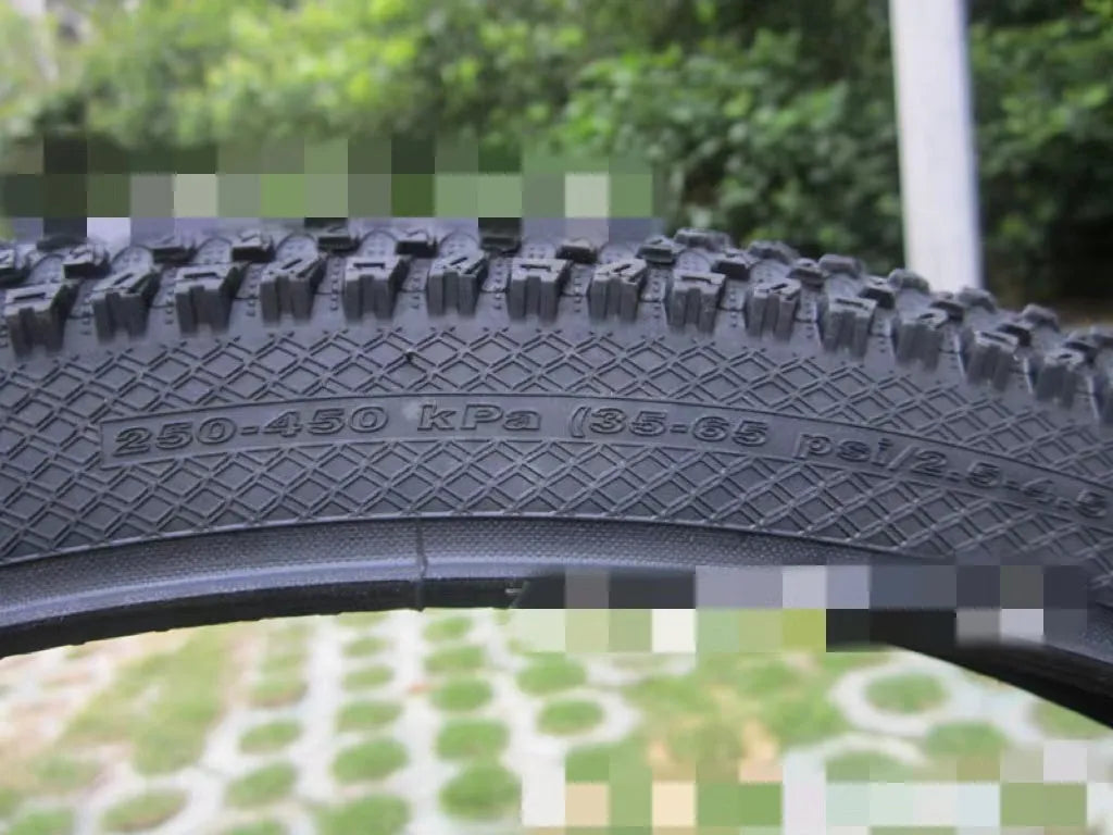 Ultralight mountain bike tyre with puncture-resistant tread, shown in a black and white sidewall style.
