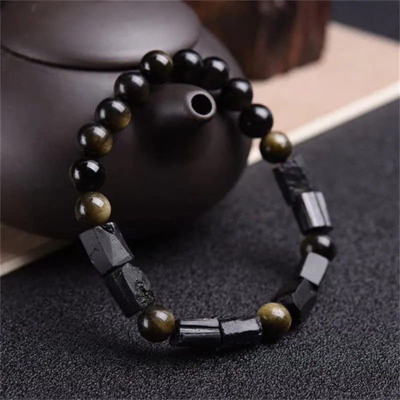 Natural obsidian single ring bracelet with constellation modelling on a wrist.