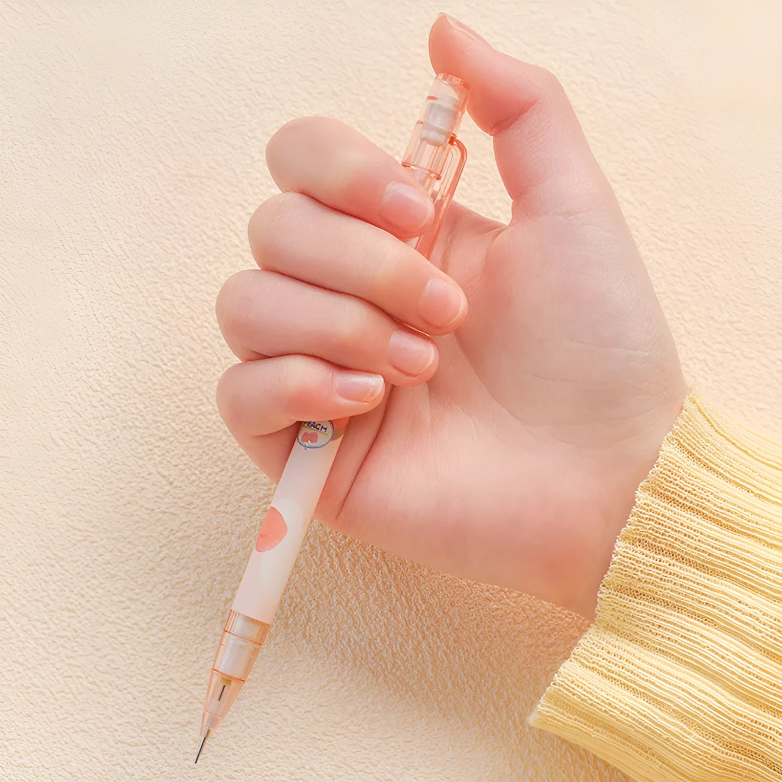 Automatic press pencil in peach colour with 0.5mm lead and refill set